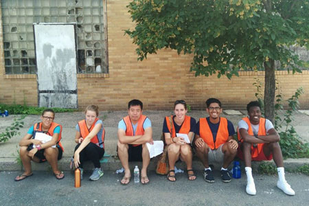 students taking notes during a visit to a neighborhood