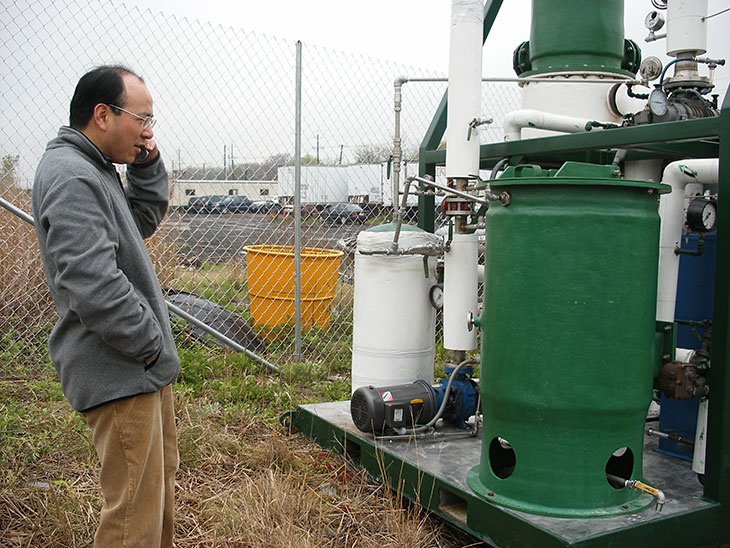 Photo: Dr. Weilin Huang and leachate distillation equipment (2005).